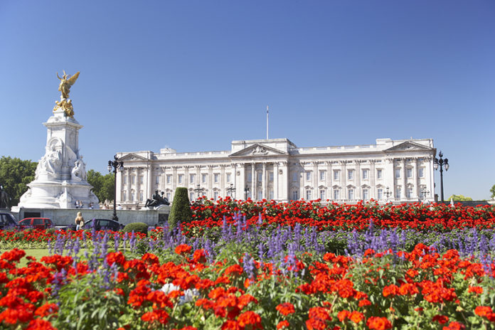 Buckingham Palace With Flowers Blooming In The Queen's Garden, London, England. Credit: Shutterstock