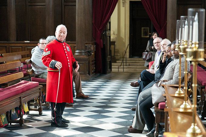 A Chelsea Pensioner gives a tour of the chapel. Royal Chelsea Hospital. Credit: Stephen Bennett