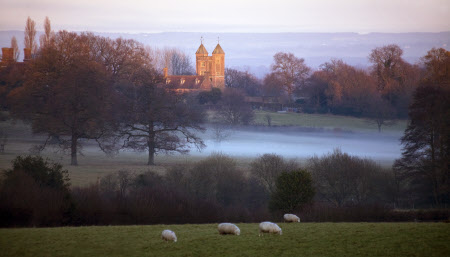 A view in December over the surrounding fields towards the Elizabethan Tower at Sissinghurst Castle Garden, Kent.
