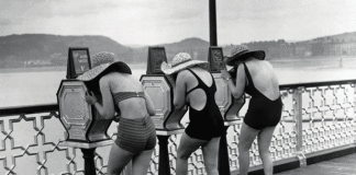 Women bathers view a peep show on Llandudno Pier. Credit: Corbis